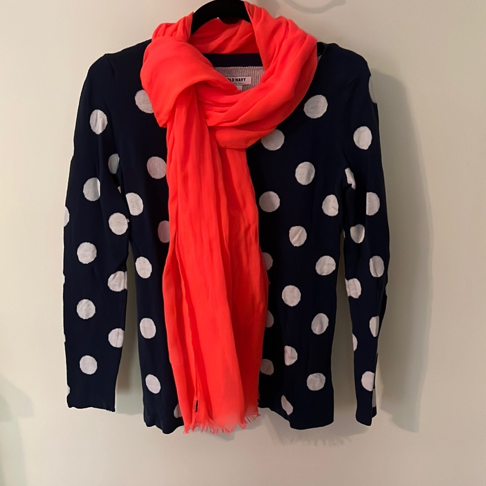 Navy blue sweater with big white polka dots and neon orange sweater